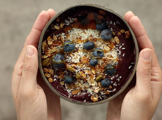 hand holding açaí bowl